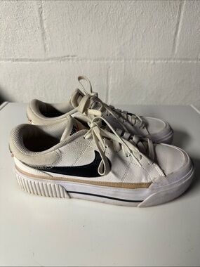 Nike White Low-Top Sneakers with Black Swoosh and Tan Stripe